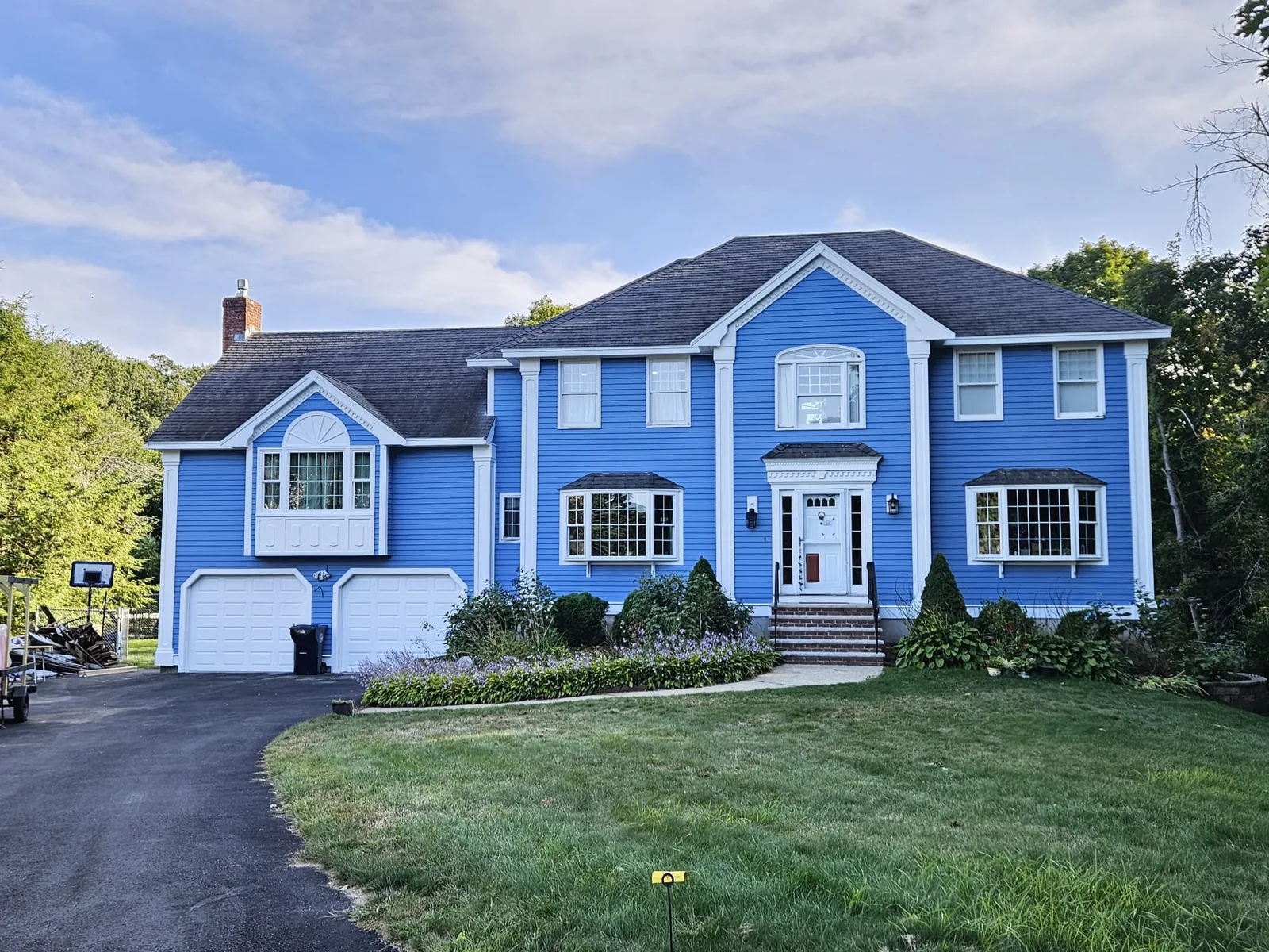 Finished two-story home with blue siding and white trim — front
